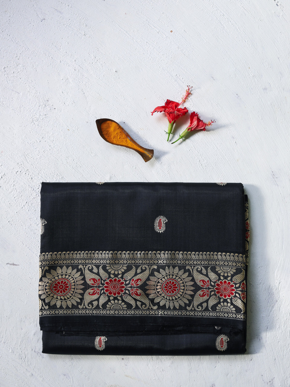 Handwoven revival Baluchari Black saree with floral patterns on a light gray background
