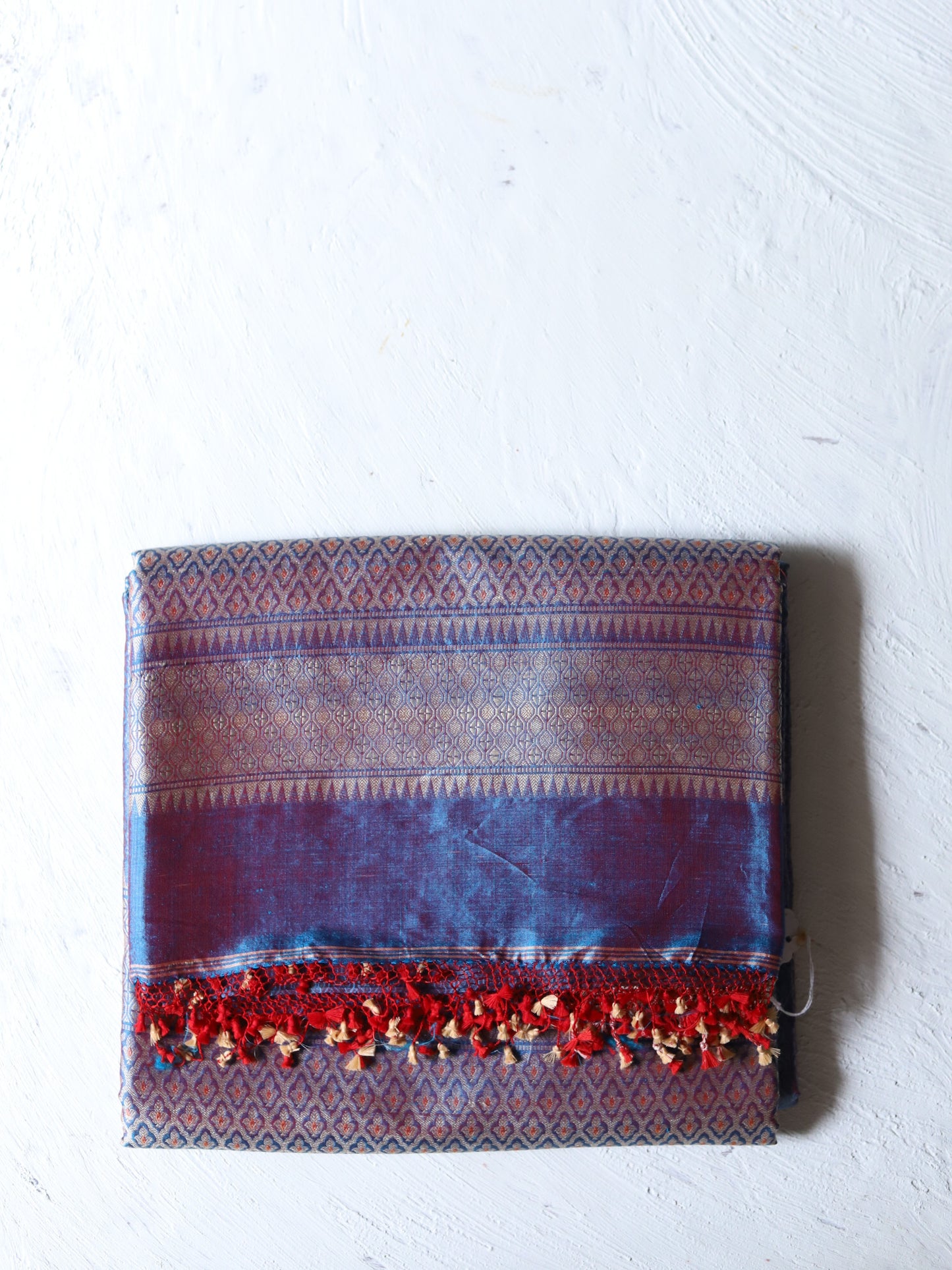 Textured fabric pouch with red accents on a white background
