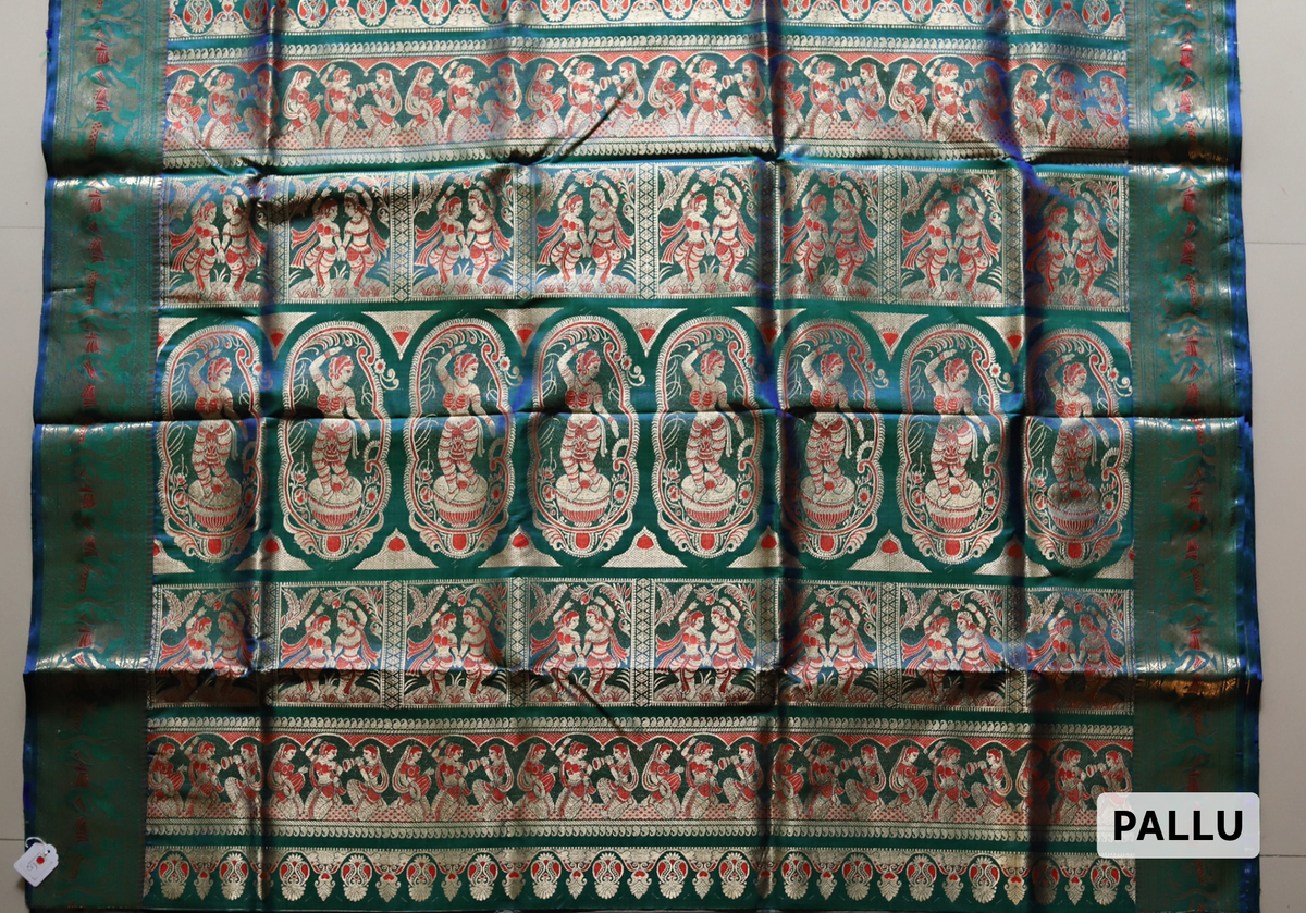 Traditional Handwoven Swarnachari Mulberry silk wedding saree for bengali bride in Teal saree with intricate patterns on a light gray background