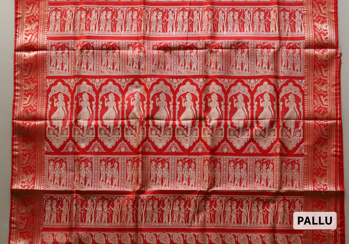 Red fabric with white patterns and 'PALLU' label of handwoven Red Bengali Baluchari wedding mulberry silk sari on a gray background