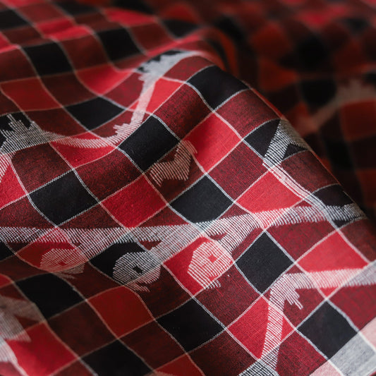 Close-up of red, black, and gray checkered fabric with small animal prints.