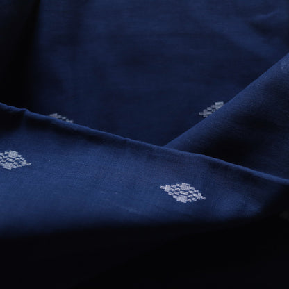 Close-up of dark blue fabric with subtle white floral patterns