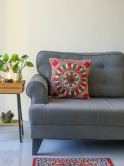 Grey sofa with a decorative with multicolour embroidered cushion cover in a living room setting