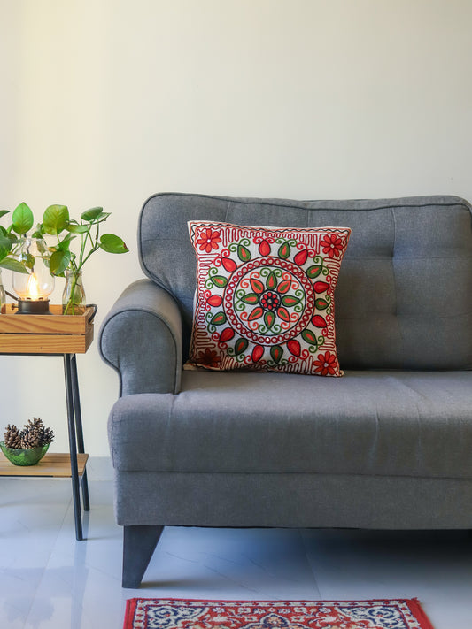 Grey sofa with a decorative with multicolour embroidered cushion cover in a living room setting