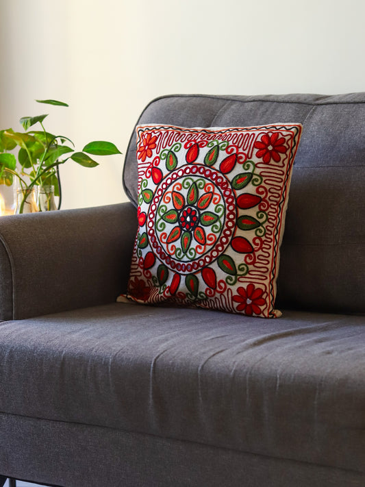 Grey sofa with a decorative with multicolour embroidered cushion cover in a living room setting
