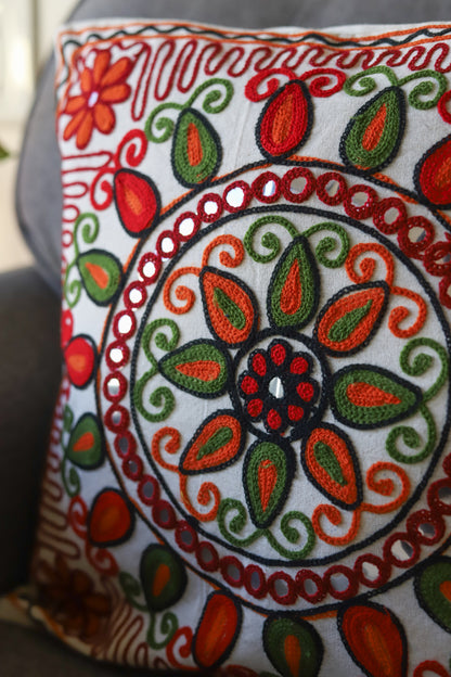 Grey sofa with a decorative with multicolour embroidered cushion cover in a living room setting