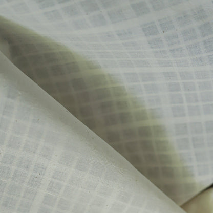 Close-up of textured handwoven khadi  fabric with a grid pattern