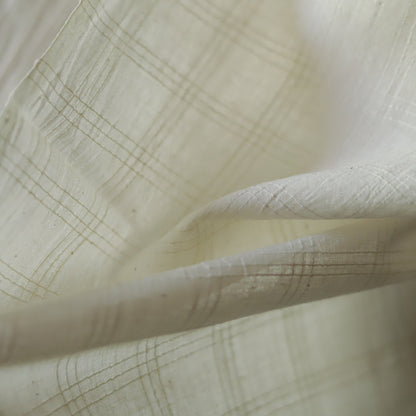 Close-up of off white handwoven pure cotton khadi fabric of West Bengal with subtle texture