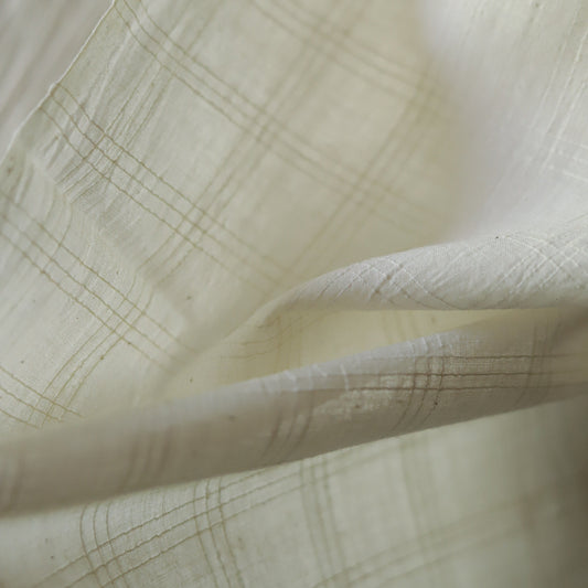 Close-up of off white handwoven pure cotton khadi fabric of West Bengal with subtle texture