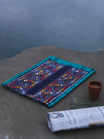 Decorative Batik Kantha Cotton Kurta Fabric with geometric pattern on a stone surface next to a cup of coffee and rolled-up newspaper.