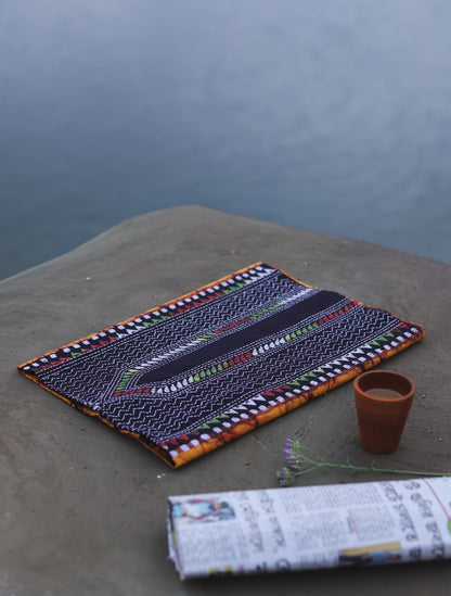 Decorative Batik Kantha Cotton Kurta Fabric with geometric pattern on a stone surface next to a cup of coffee and rolled-up newspaper.
