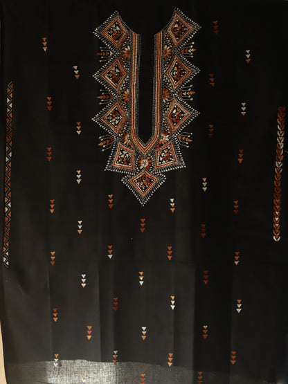 Black fabric with intricate geometric embroidery in brown and gold