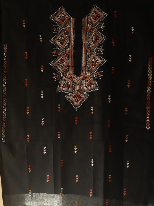 Black fabric with intricate geometric embroidery in brown and gold