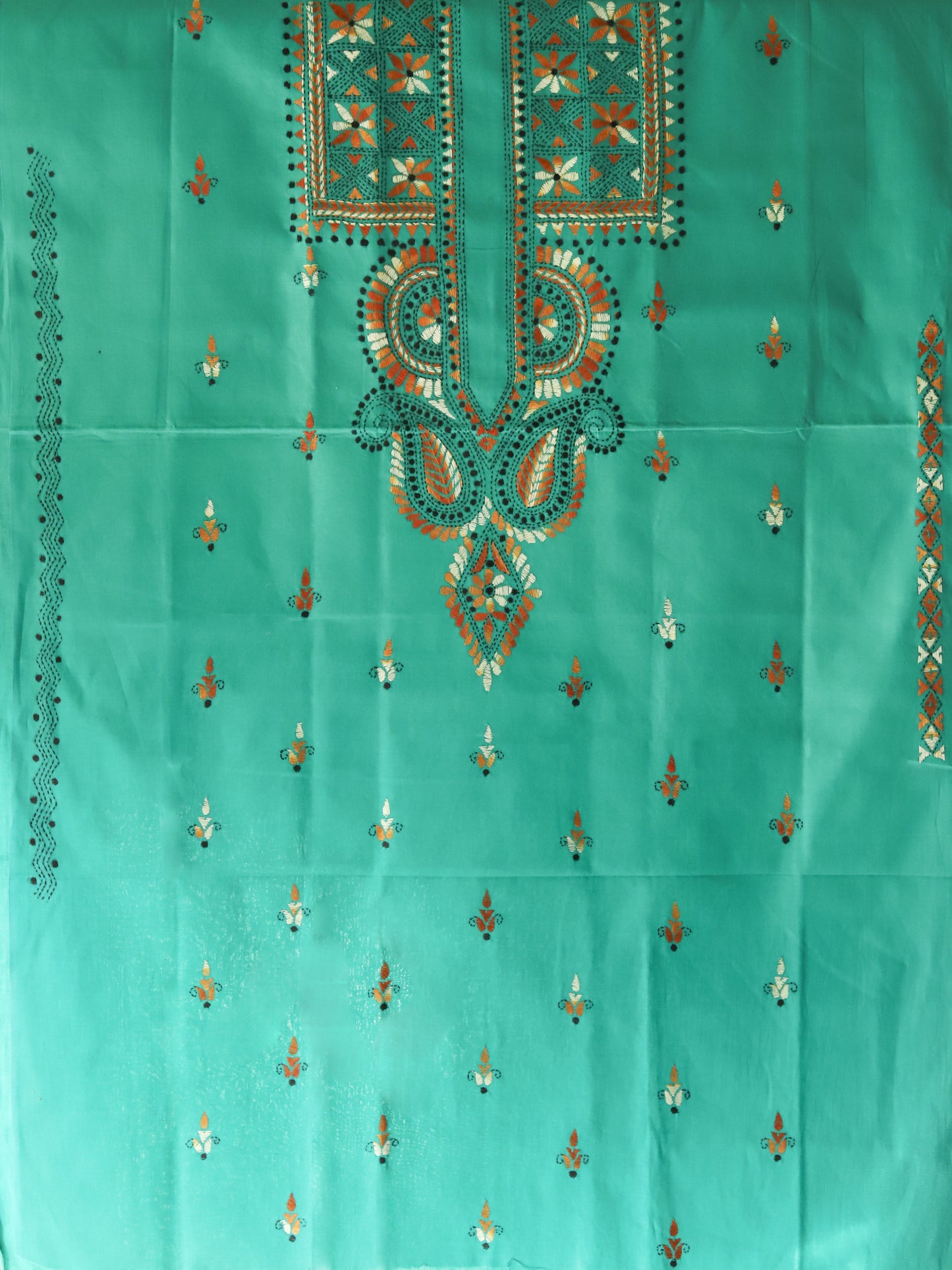 Turquoise fabric with intricate embroidery