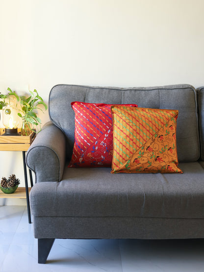 Gray sofa with colorful hand emberoidered Bengal kantha pillows in a room setting