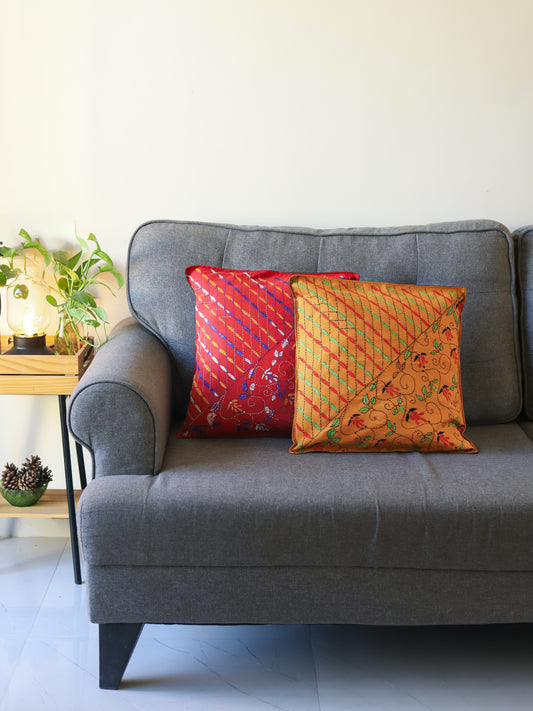 Gray sofa with colorful hand emberoidered Bengal kantha pillows in a room setting