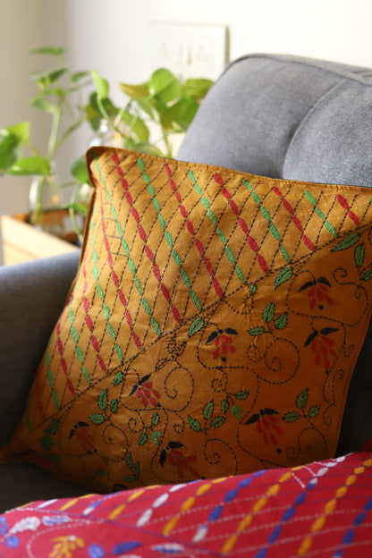 Decorative hand emberoidered Bengal kantha  pillow with intricate patterns on a couch