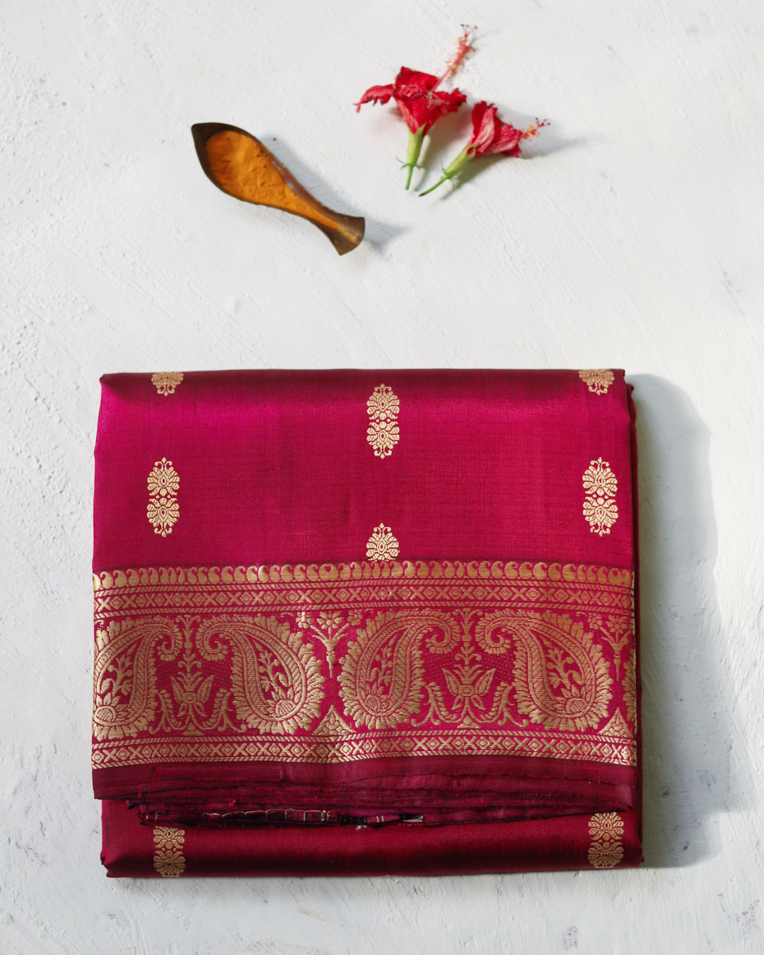 not traditional Handwoven Baluchari Mulberry silk saree in Magenta with gold patterns on a light background