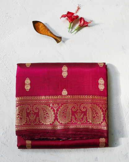 not traditional Handwoven Baluchari Mulberry silk saree in Magenta with gold patterns on a light background