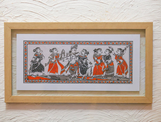 Framed artwork with traditional design on a textured wall