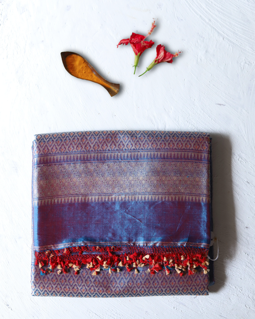 Handwoven Benarasi Mulberry silk wedding saree for bengali bride in Red Blue saree with intricate patterns on a light grey background