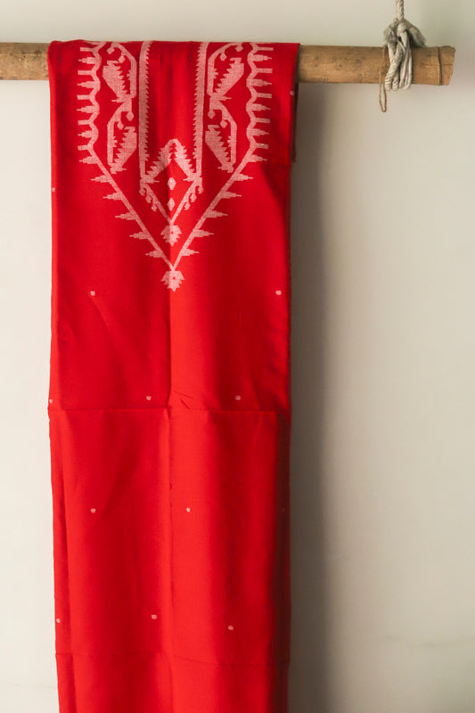 hand woven pure muslin cotton fabric of West Bengal  hanging on a wooden rod against a beige wall.