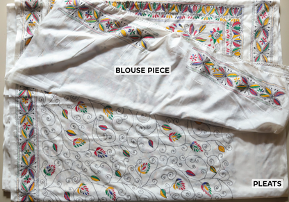 White blouse piece with colorful floral patterns on a plain background